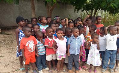Large group of children gathered outside in Bombardopolis